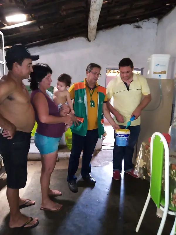 Entrega do Purafiltra a uma família, com a equipe do projeto